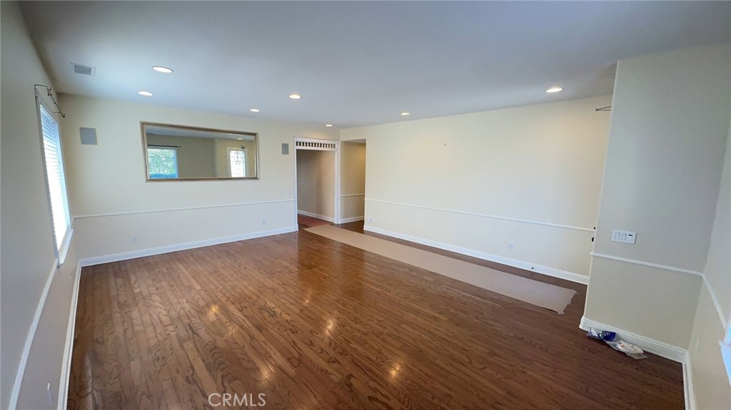 38265 Birch Court Murrieta, CA 92562 - Photo 6 of 46 an empty room with wooden floor and windows