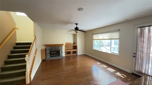 wooden floor in an empty room with a fireplace