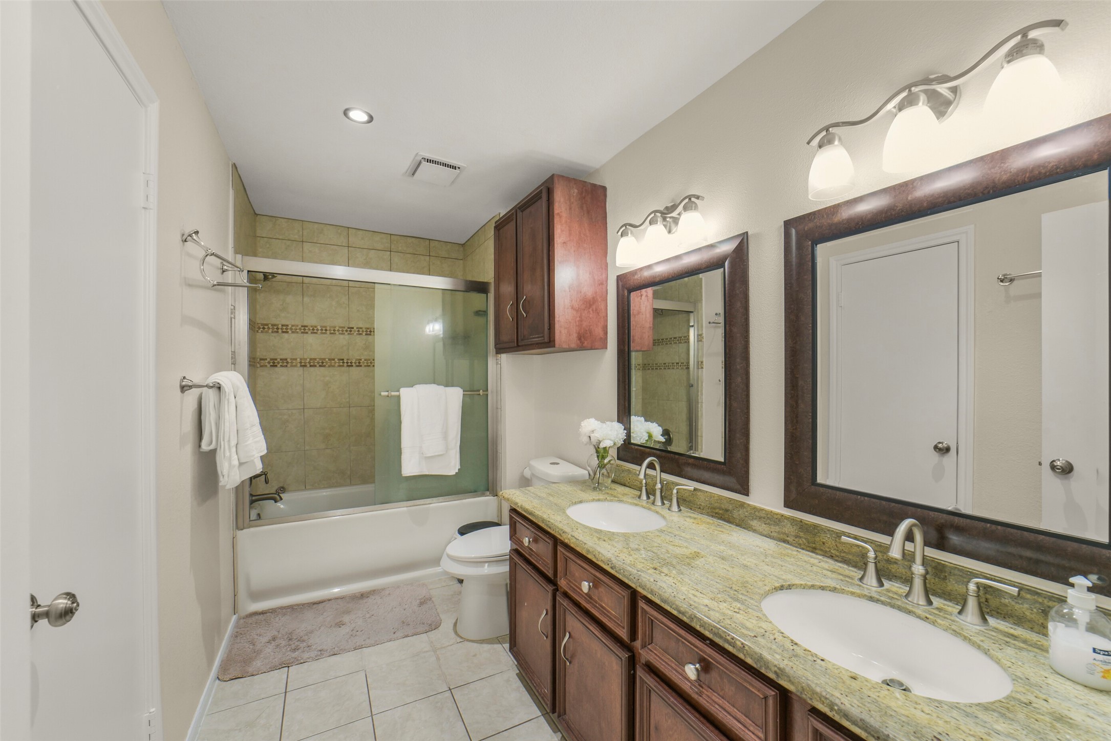 5707 Innsbruck Street Bellaire, TX 77401 - Photo 30 of 35 Double vanity countertop. Sliding glass tub doors.
