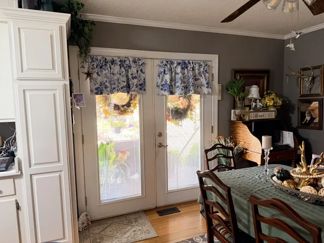 a kitchen with stainless steel appliances a sink a stove a table and chairs