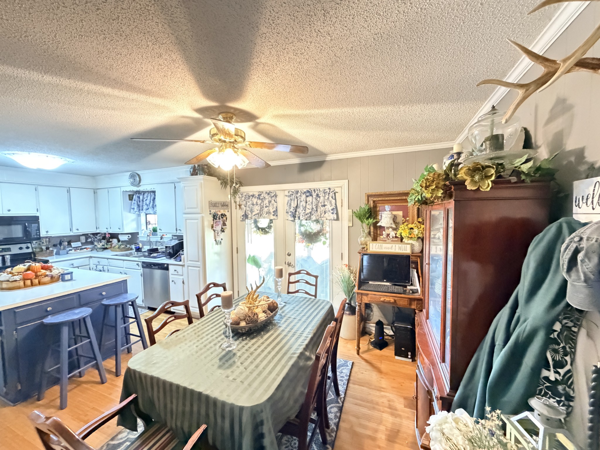2890 Nance Bend Road Clifton, TN 38425 - Photo 13 of 52 a view of a dining room and livingroom with furniture wooden floor a chandelier