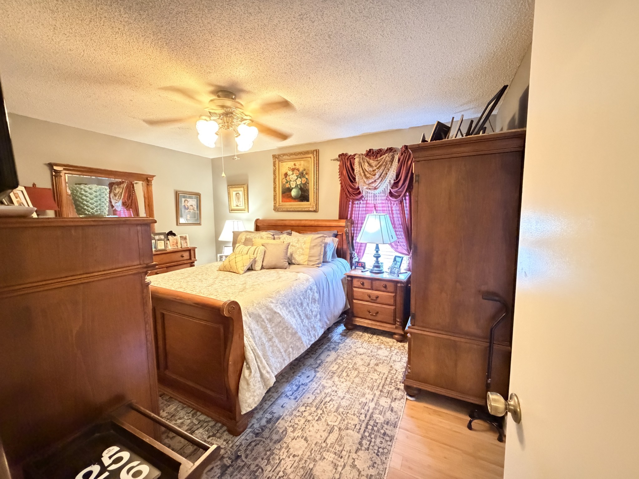2890 Nance Bend Road Clifton, TN 38425 - Photo 22 of 52 a bedroom with a bed and a chandelier