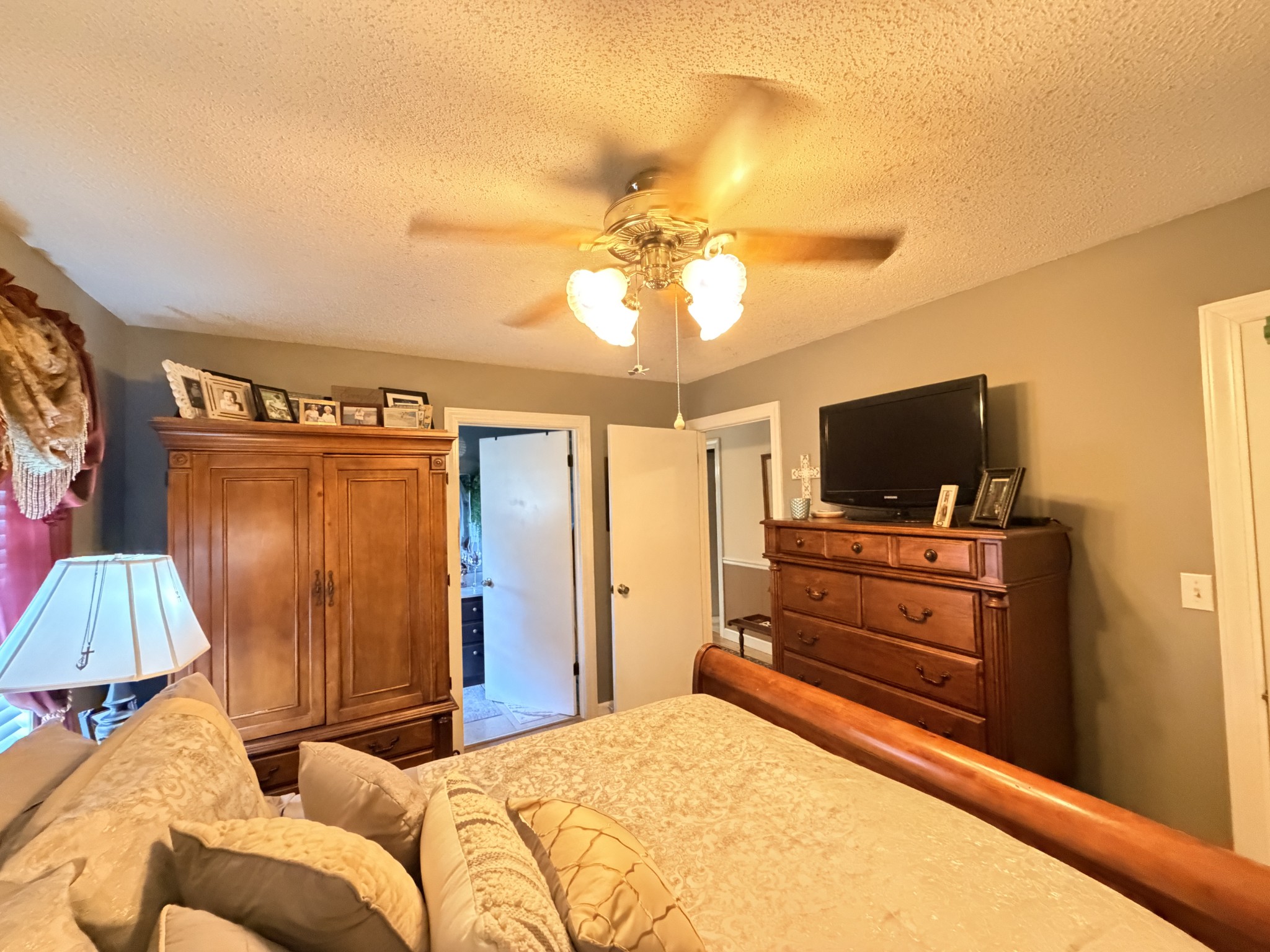 2890 Nance Bend Road Clifton, TN 38425 - Photo 26 of 52 a bedroom with a bed and a flat screen tv