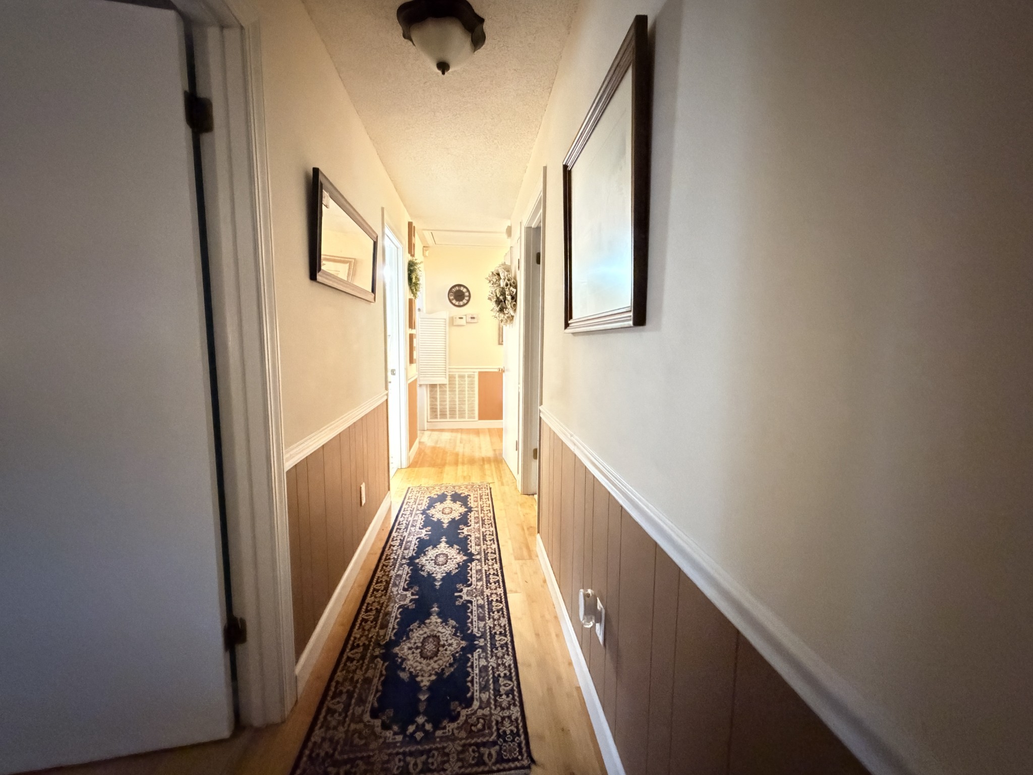 2890 Nance Bend Road Clifton, TN 38425 - Photo 28 of 52 a view of a hallway with wooden floor and staircase