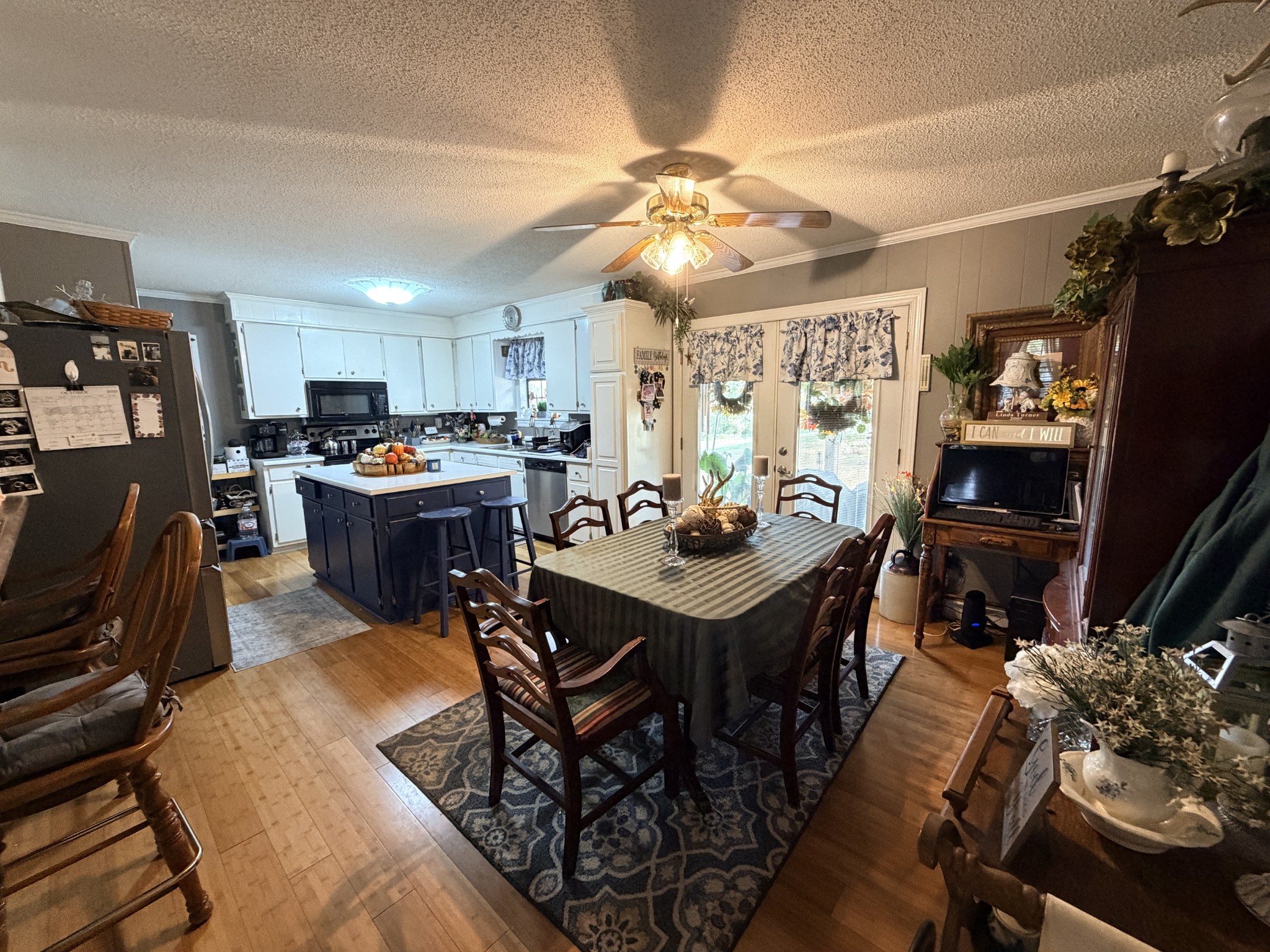 2890 Nance Bend Road Clifton, TN 38425 - Photo 9 of 52 a view of a dining room with furniture and a flat screen tv