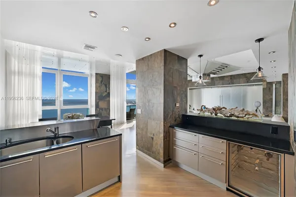 a kitchen with stainless steel appliances granite countertop a sink and cabinets