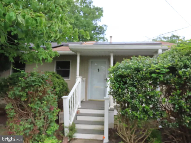 a view of a house with a flower garden