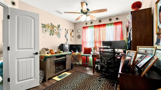 a view of a workspace with furniture and a window