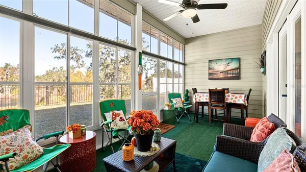 a living room filled with furniture and a large window