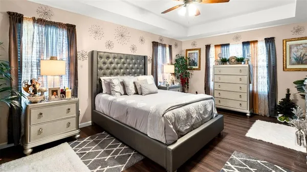 a bedroom with a large bed and a dresser