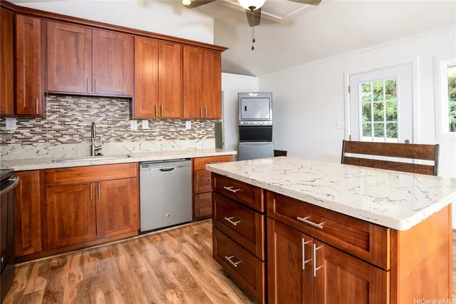 a kitchen with stainless steel appliances granite countertop wooden cabinets a sink and dishwasher