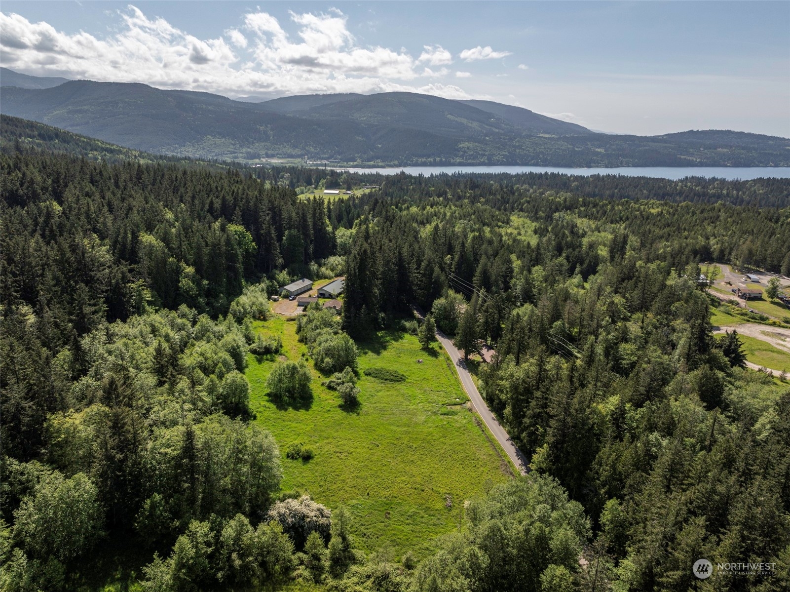 1434 Chicken Coop Road Sequim, WA 98382 - Photo 1 of 25 a view of a lush green hillside and houses