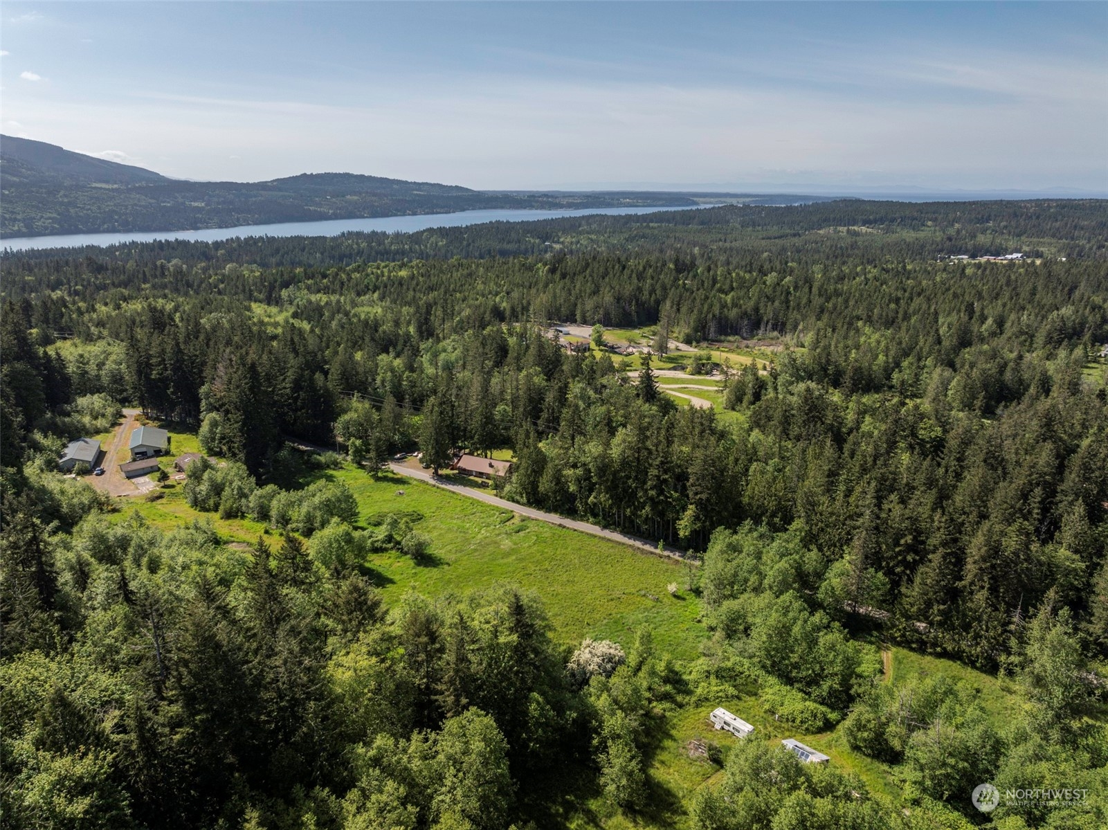 1434 Chicken Coop Road Sequim, WA 98382 - Photo 7 of 25 a view of a city with lush green forest