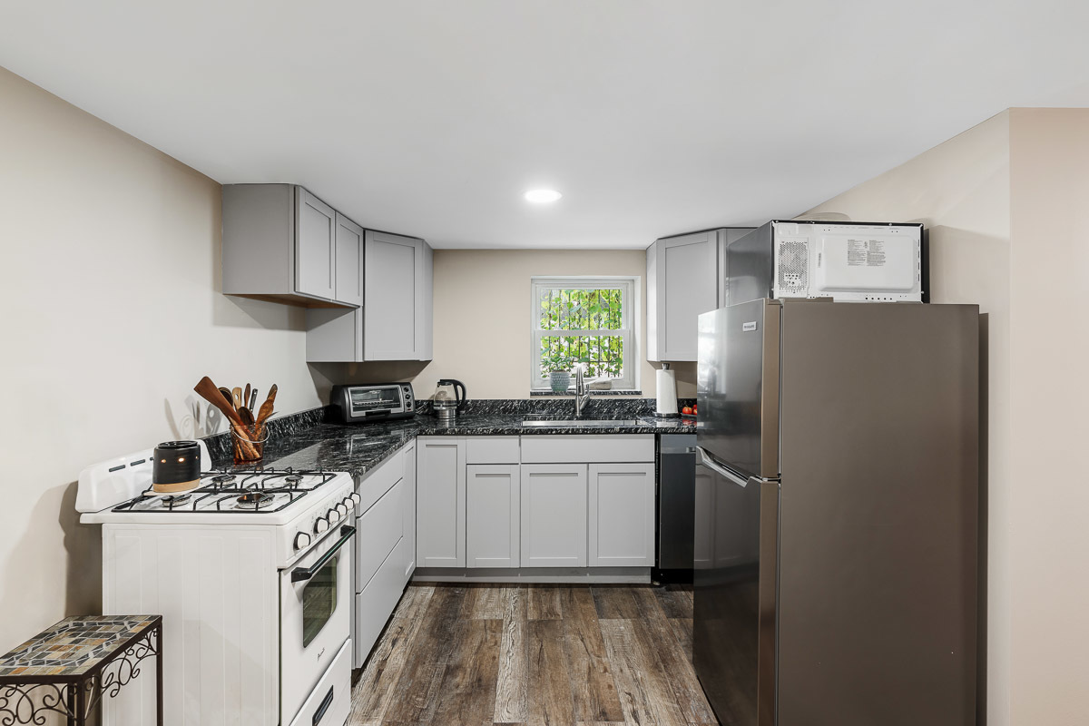 1301 West Nelson Street, Unit G Chicago, IL 60657 - Photo 5 of 19 a kitchen with a sink a refrigerator a stove and cabinets