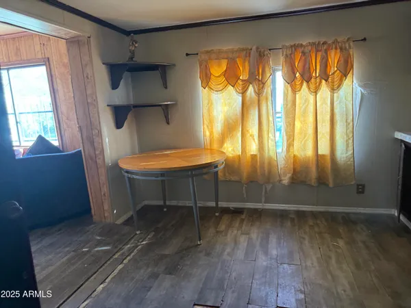a room with wooden floor and a window