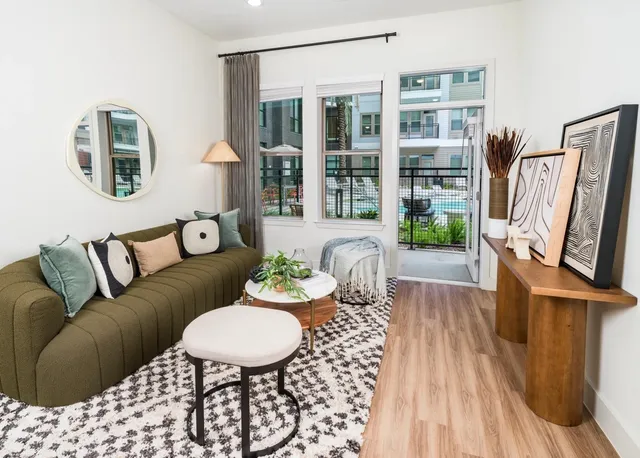 a kitchen with a sink a stove a refrigerator and white cabinets with wooden floor