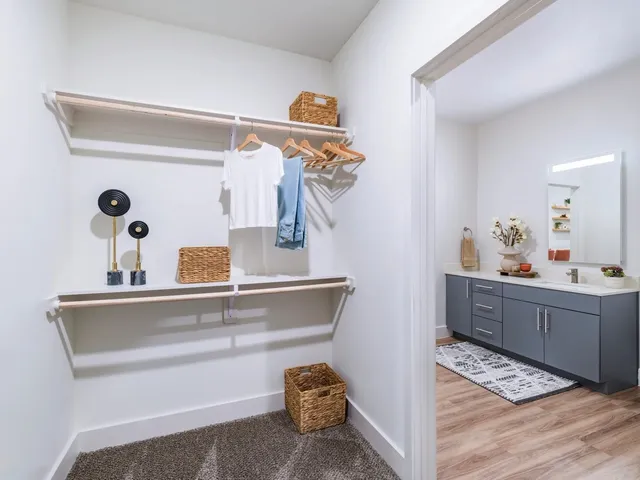 a kitchen with stainless steel appliances a sink a stove a refrigerator cabinets and wooden floor