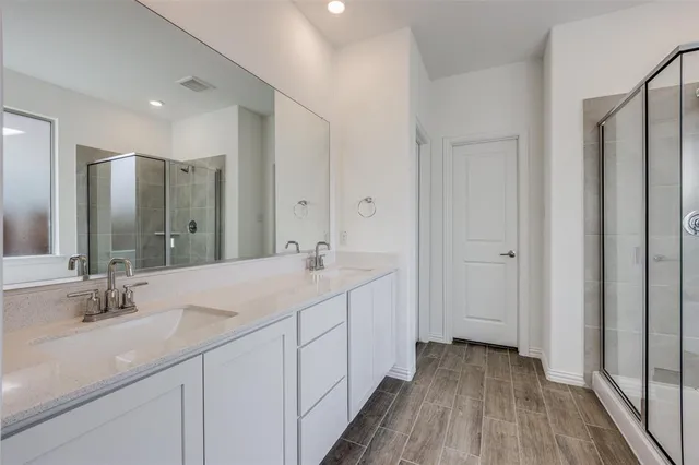 a bathroom with a double vanity sink and mirror