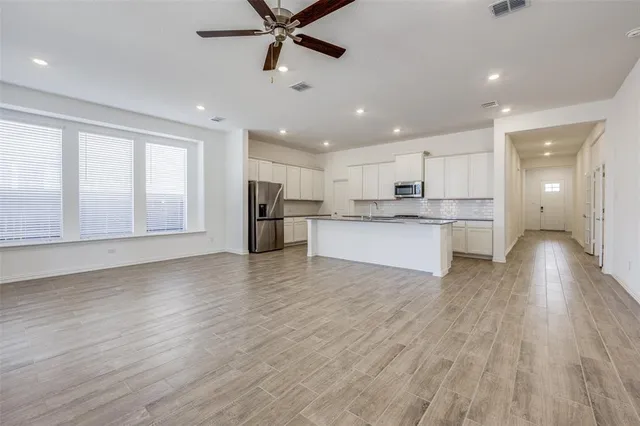 a view of a kitchen with a sink and a refrigerator