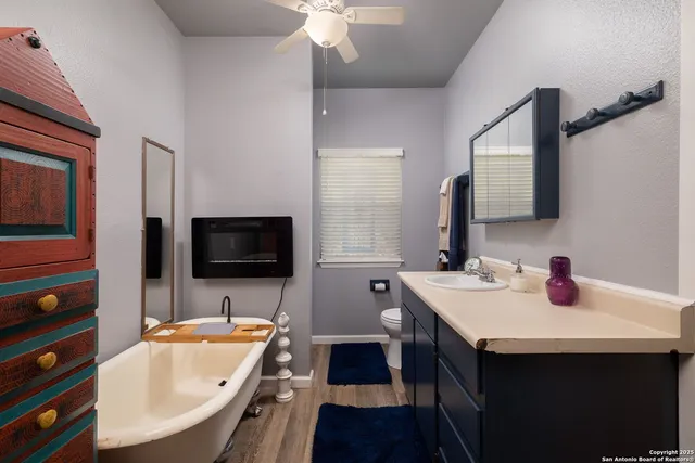 a view of a kitchen area with furniture and wooden floor
