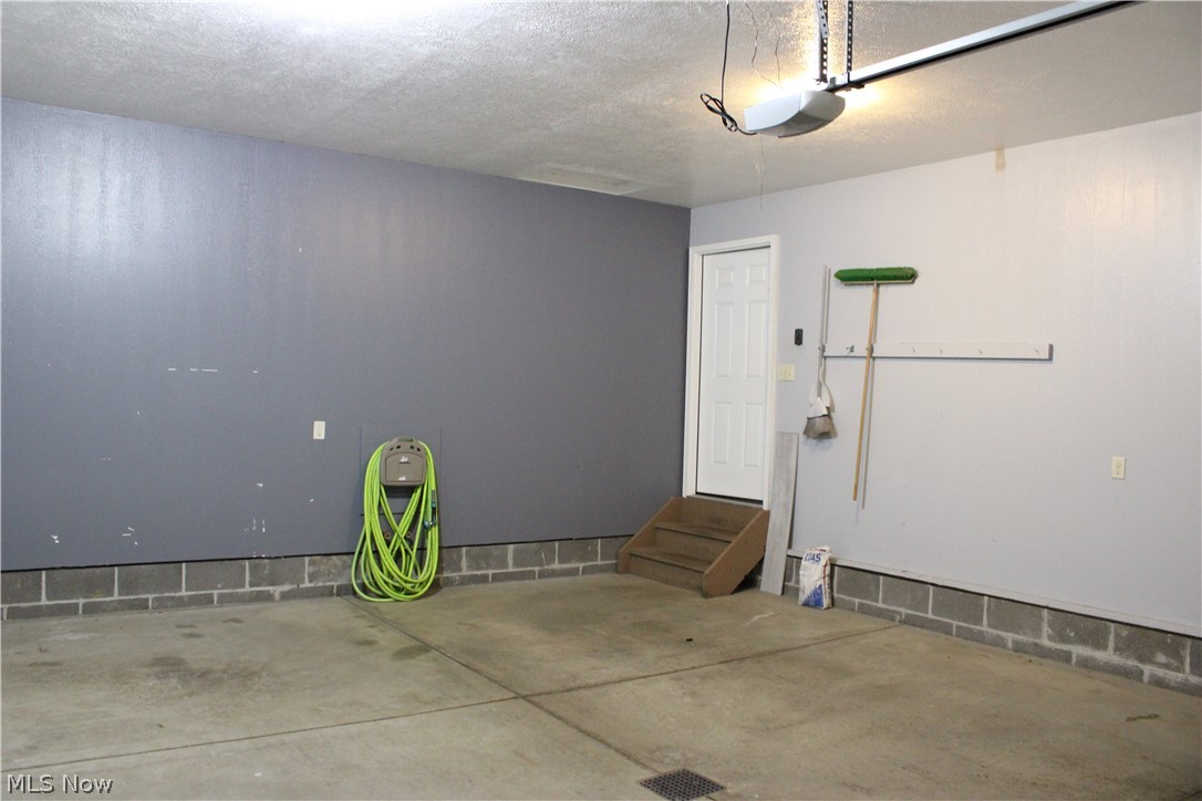 202 Home Street Rittman, OH 44270 - Photo 45 of 47 Attached garage with concrete flooring, block wall foundation, and automatic garage door opener