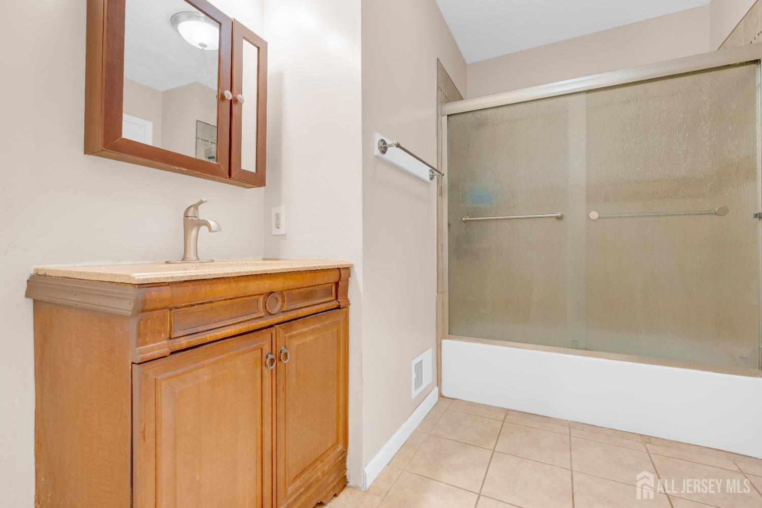 90 Pheasant Run Edison, NJ 08820 - Photo 12 of 39 a bathroom with a sink and a mirror