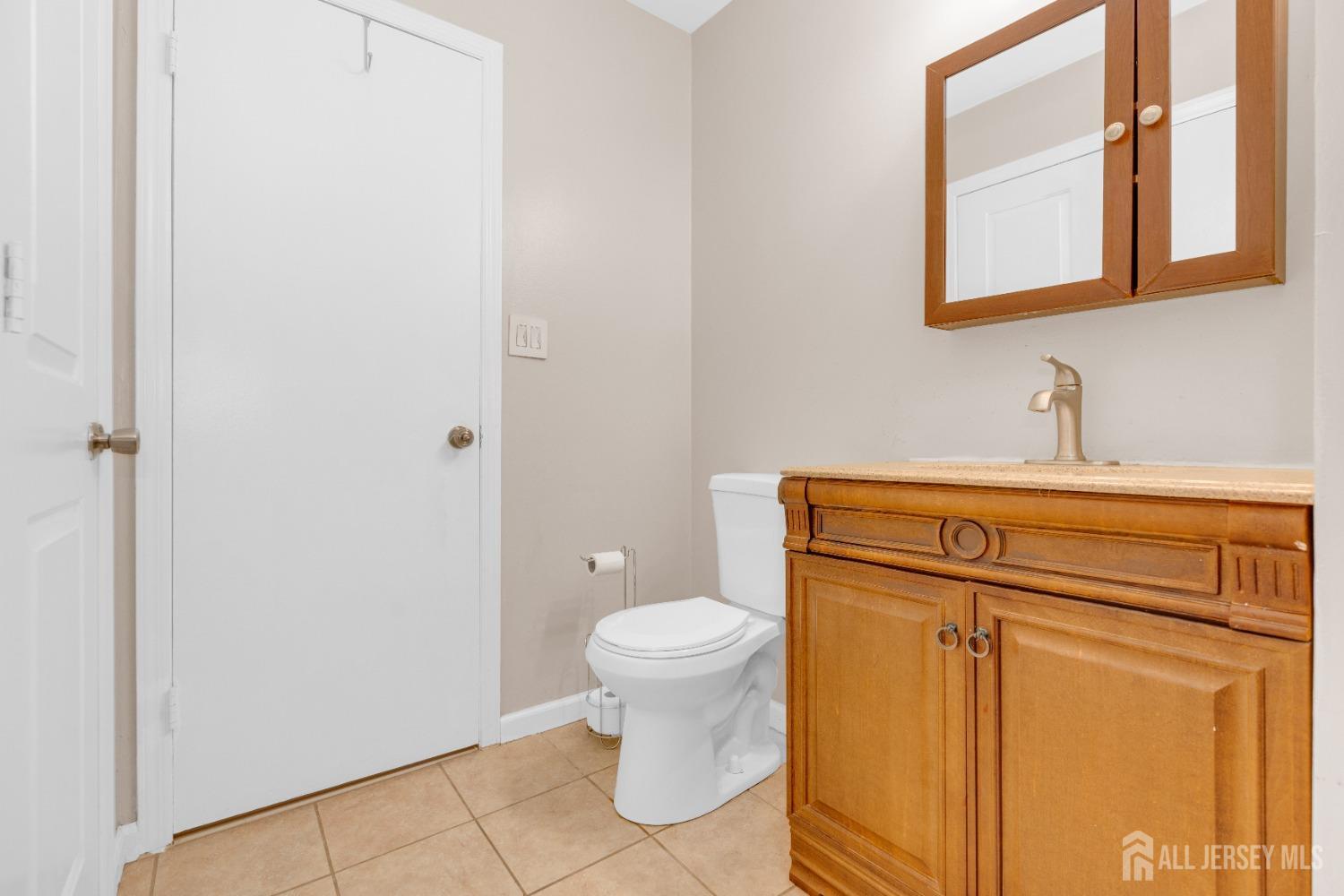 90 Pheasant Run Edison, NJ 08820 - Photo 13 of 39 a bathroom with a toilet sink and mirror
