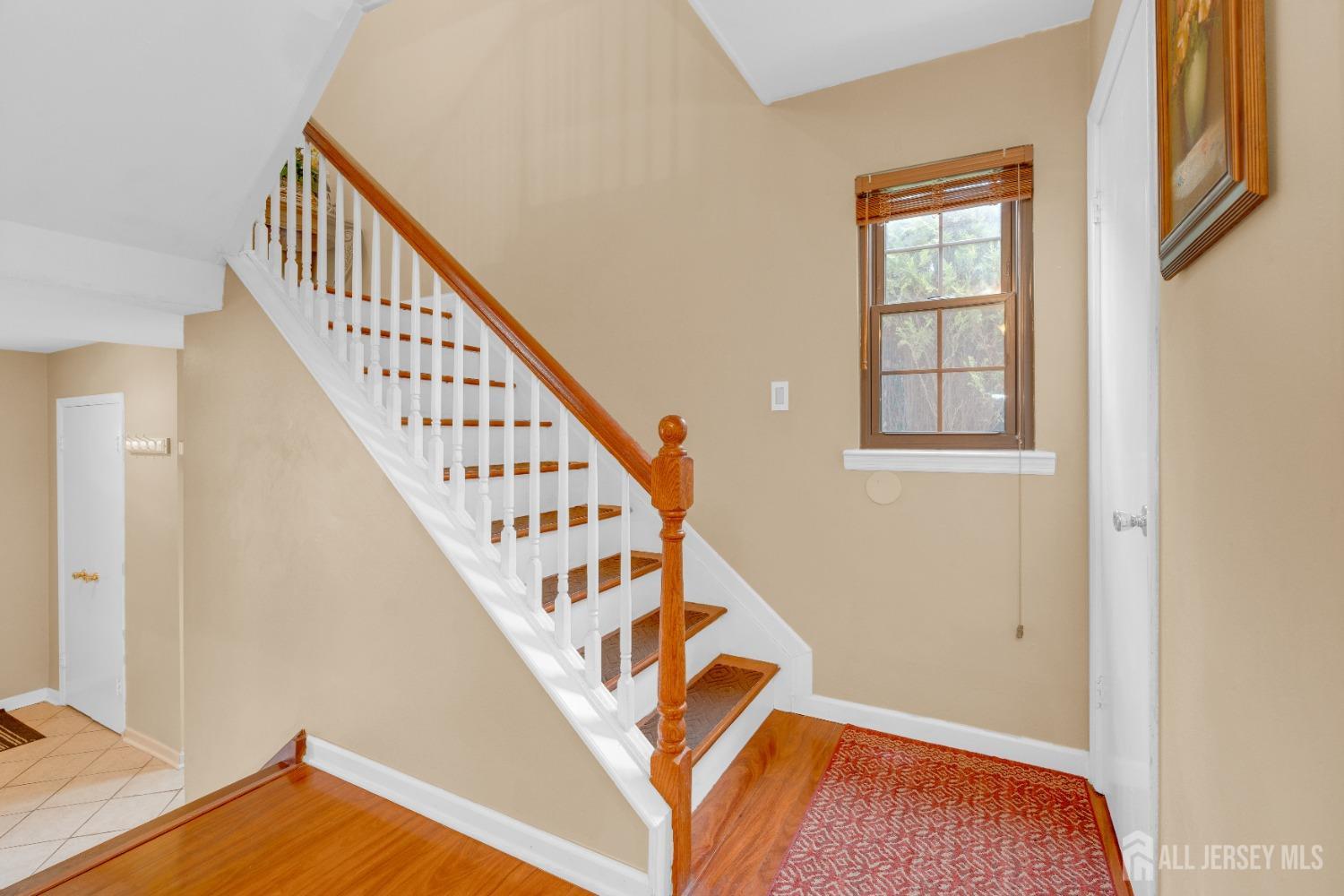 90 Pheasant Run Edison, NJ 08820 - Photo 15 of 39 a view of entryway with wooden floor and stairs