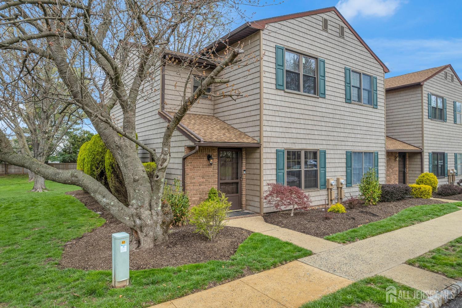 90 Pheasant Run Edison, NJ 08820 - Photo 2 of 39 a front view of a house with garden and porch