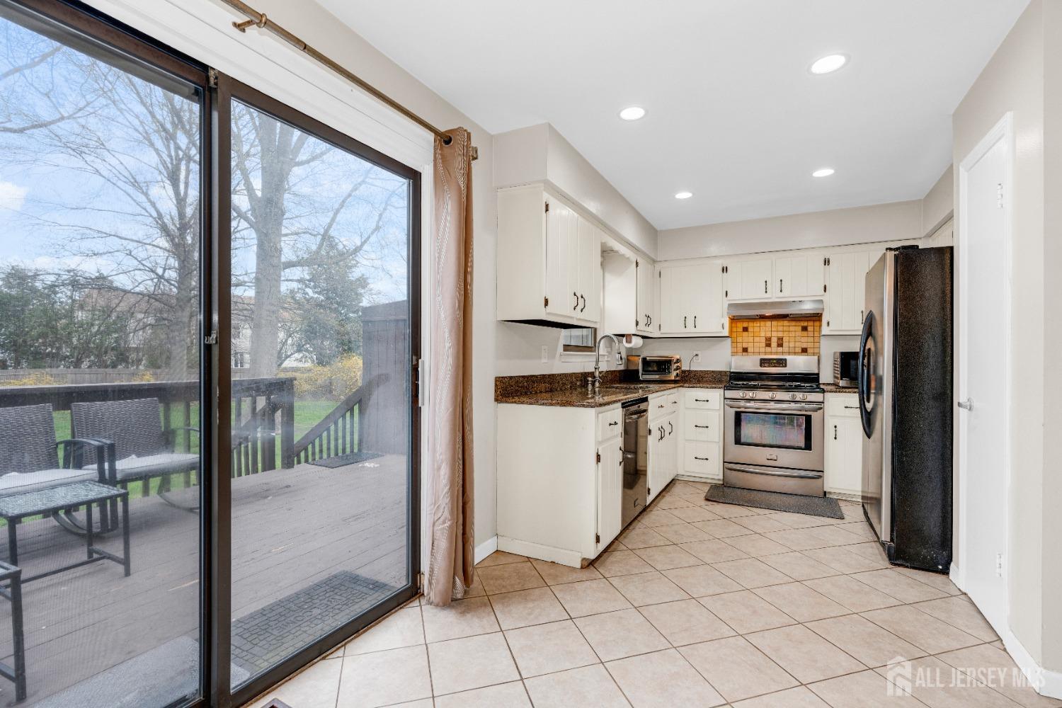 90 Pheasant Run Edison, NJ 08820 - Photo 30 of 39 a kitchen with white cabinets appliances and furniture