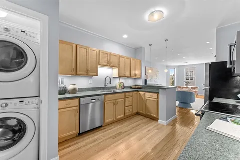 a kitchen with a sink a stove and cabinets