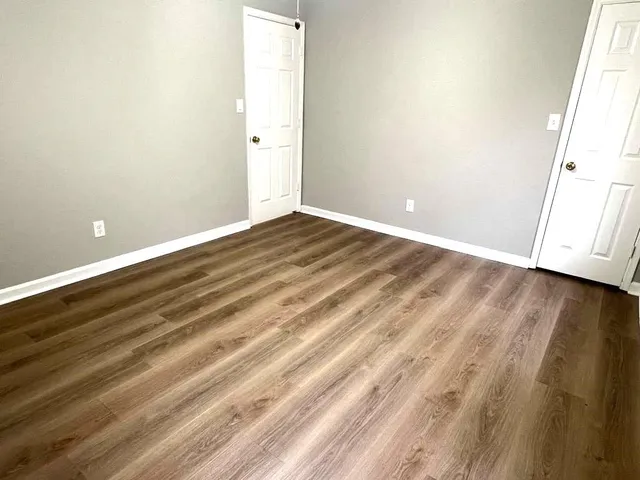 a view of room with wooden floor