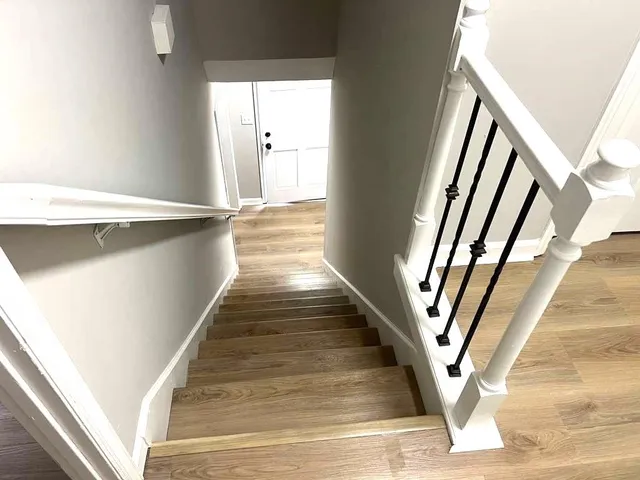 a view of entryway and hall with wooden floor