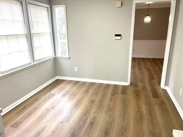 a view of an empty room and wooden floor