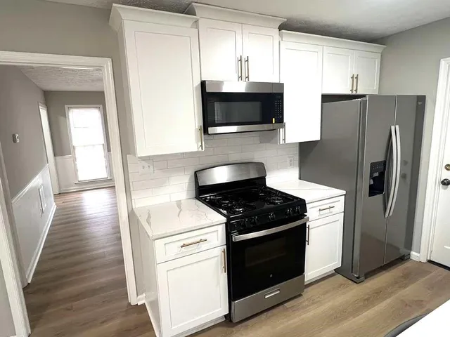 a kitchen with a stove microwave and refrigerator