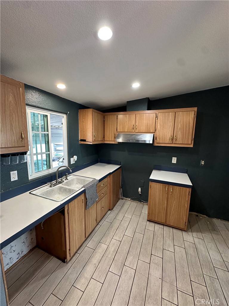 3825 Crestmore Road, Unit 414 Riverside, CA 92509 - Photo 6 of 31 a kitchen with stainless steel appliances granite countertop a sink counter space cabinets and a window