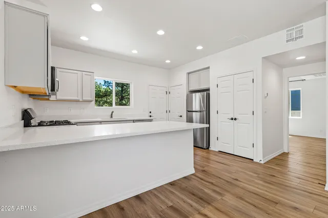 a kitchen with a sink cabinets and stainless steel appliances