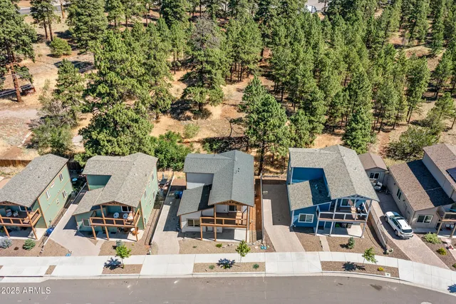 an aerial view of residential houses with outdoor space