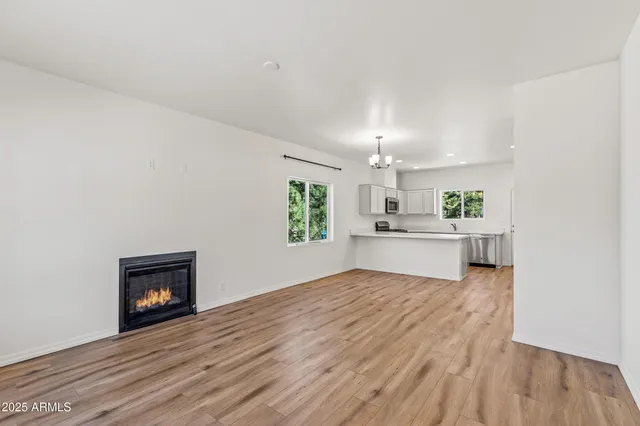a view of a kitchen with wooden floor and electronic appliances