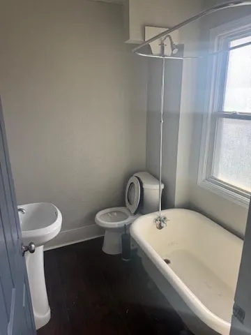 a white toilet sitting next to a bathroom sink
