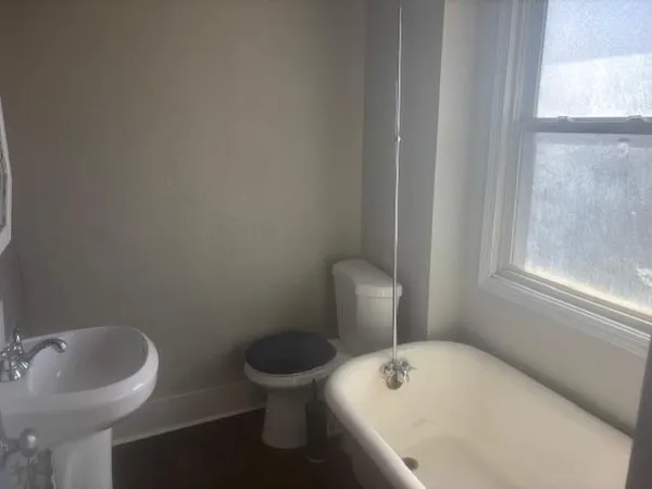 a white toilet sitting next to a bathroom sink