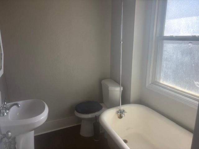 855 Vankirk Street, Unit 1 Clairton, PA 15025 - Photo 7 of 8 a white toilet sitting next to a bathroom sink