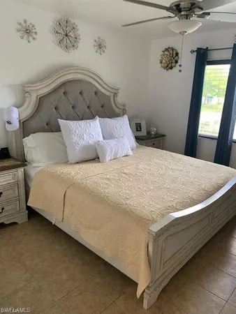 a large bed sitting in a bedroom next to a window