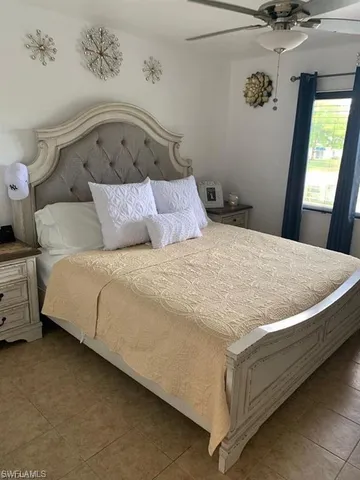 a large bed sitting in a bedroom next to a window
