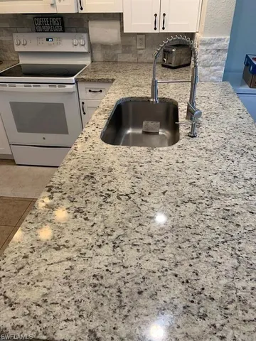 a kitchen with a sink and cabinets
