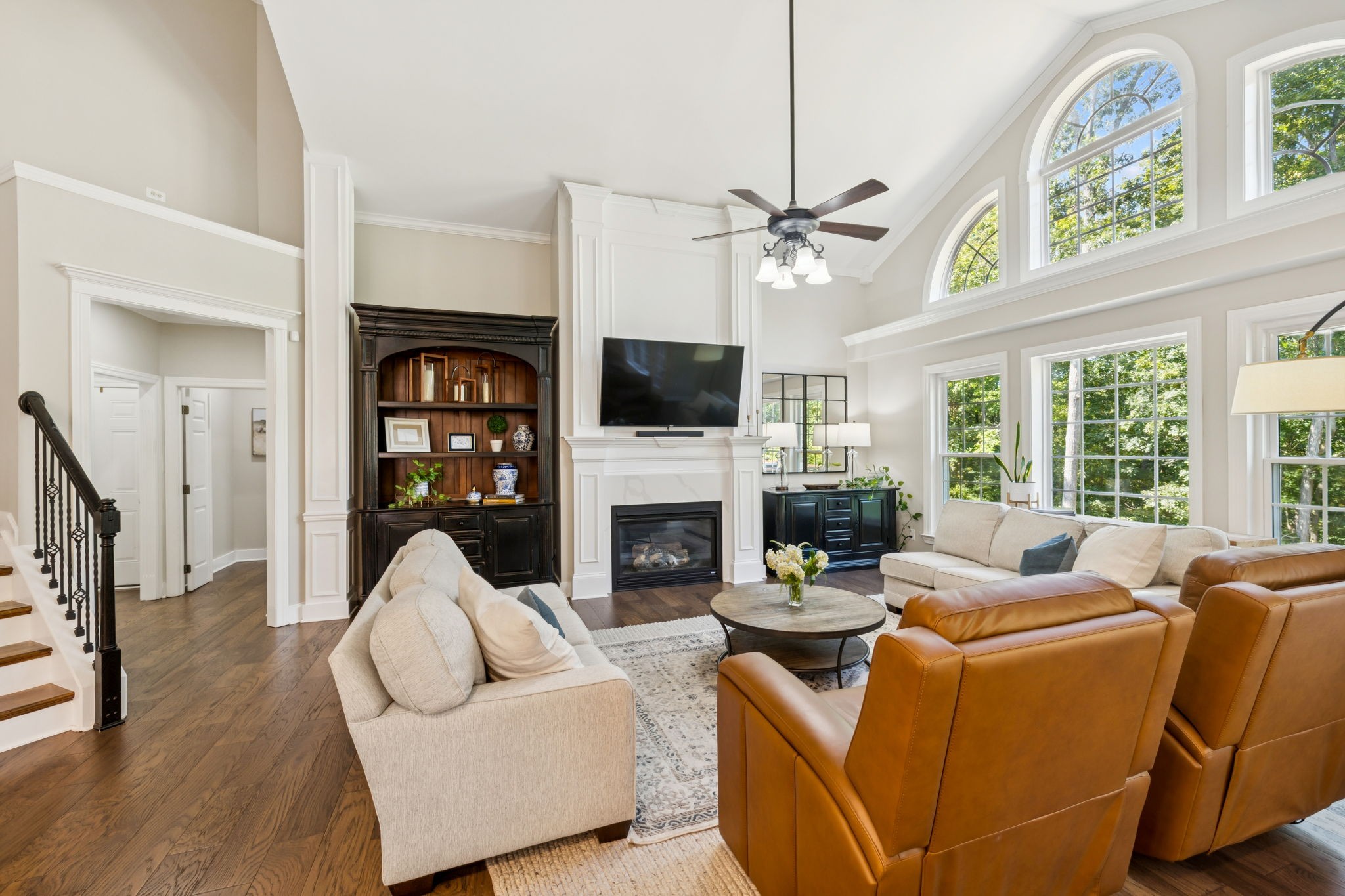 5520 Rathkeale Lane Franklin, TN 37067 - Photo 28 of 89 a living room with furniture a fireplace a flat screen tv and a large window