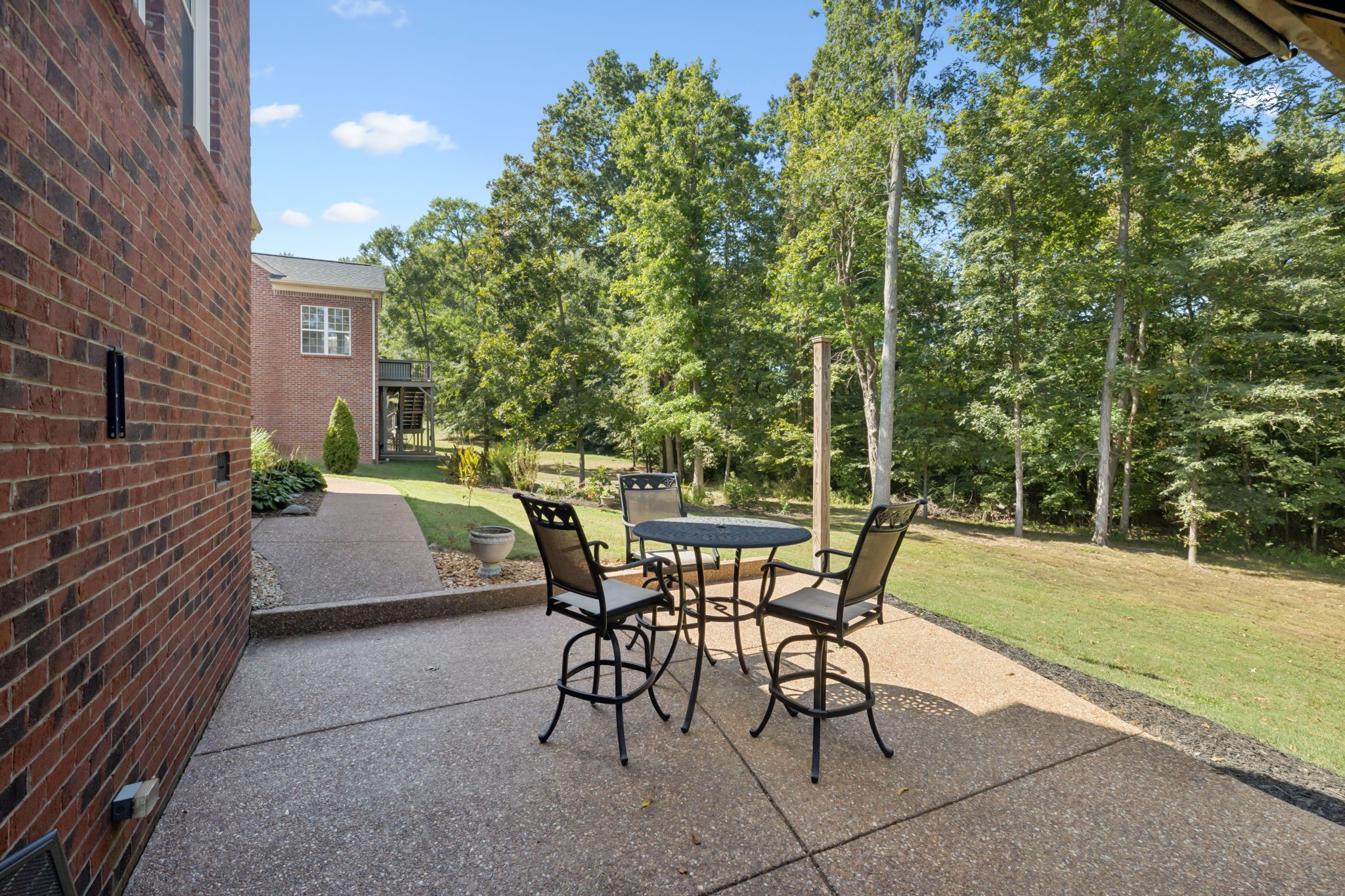 5520 Rathkeale Lane Franklin, TN 37067 - Photo 64 of 89 a view of a patio with table and chairs and potted plants with wooden floor and fence
