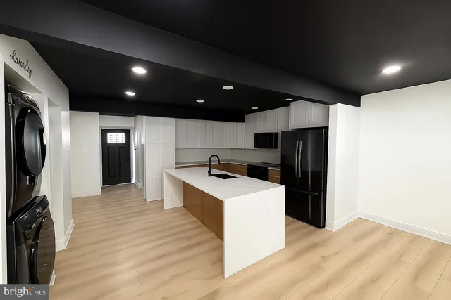 a kitchen with stainless steel appliances a refrigerator and a stove top oven