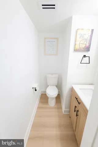 a spacious bathroom with a toilet sink and a mirror