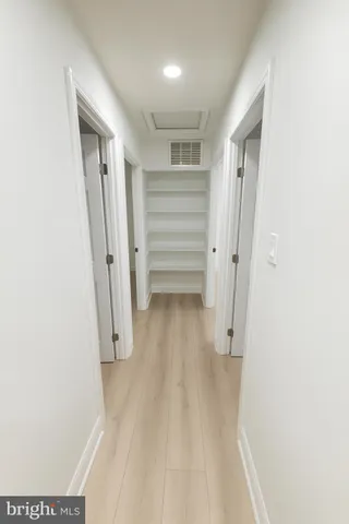 a view of walk in closet with empty racks